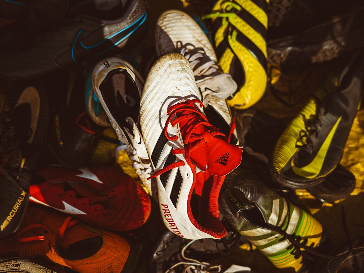 A bunch of shoes that are laying on the ground